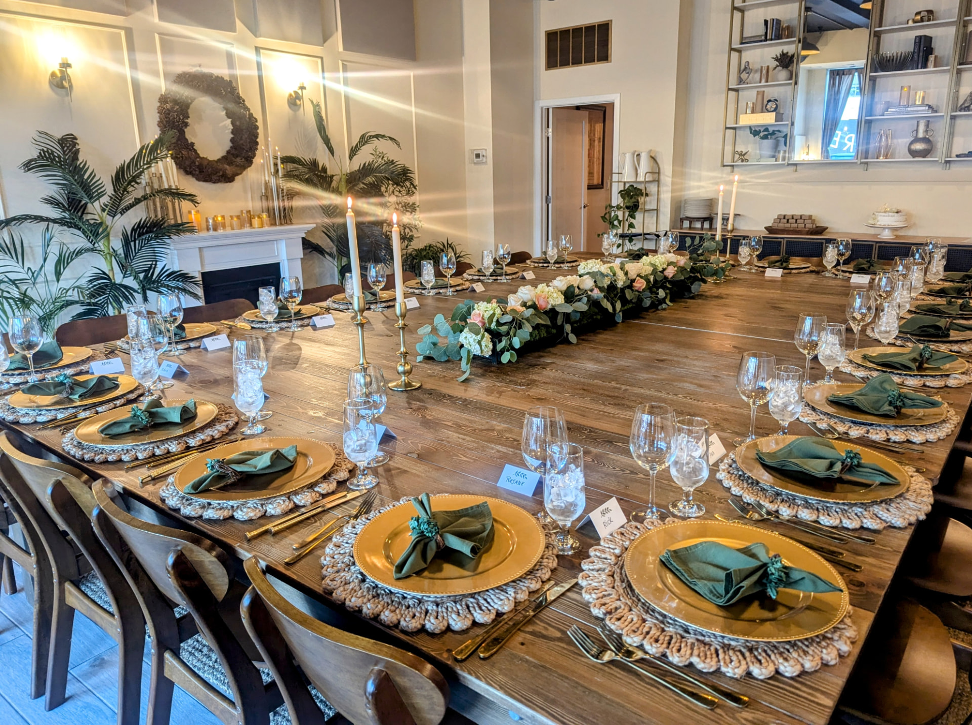 The private dining room at Greer Southern Table, a long table dressed for a dinner with candles, flowers and place cards